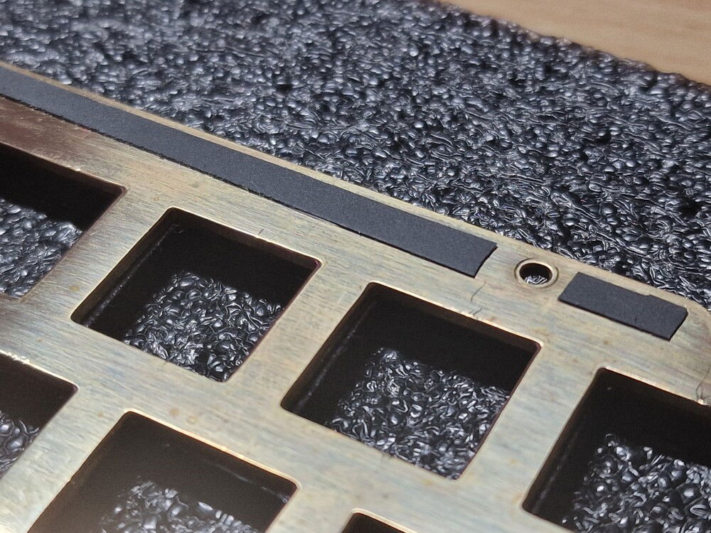 Used some material of the KBDfans StabPads to break the metal-on-metal connection of the plate to the aluminium case